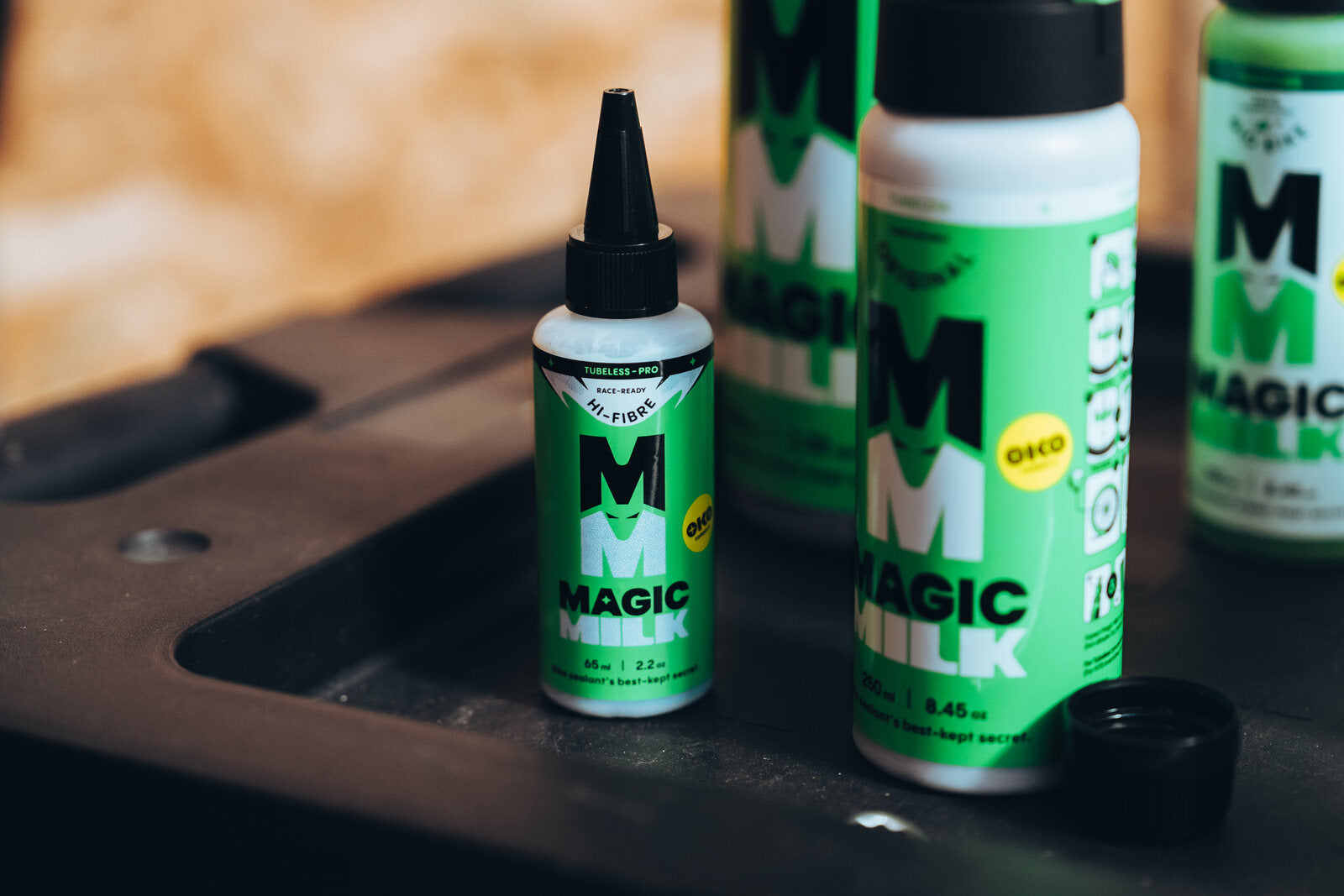 Magic Milk tubeless sealant bottles on a workshop bench
