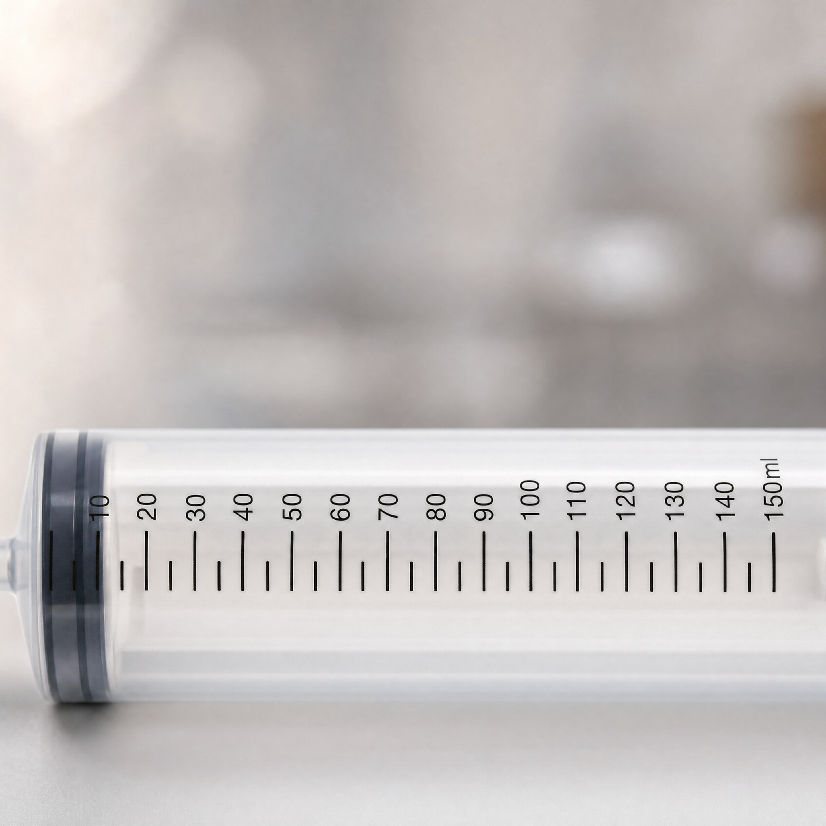 Close-up of the Magic Milk injector's graduated 150 ml barrel