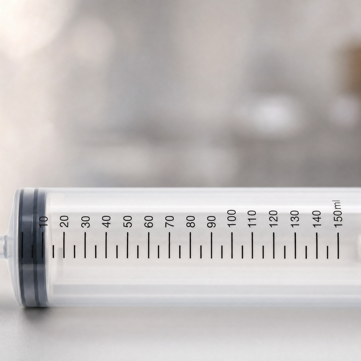 Close-up of the Magic Milk injector's graduated 150 ml barrel